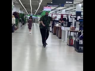 max fadeev rides a scooter around the store